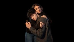 Actors Catherine Rees and Cormac McAlinden embrace. She's looking worryingly at us, while he's holding a lighter and is looking at the flame.